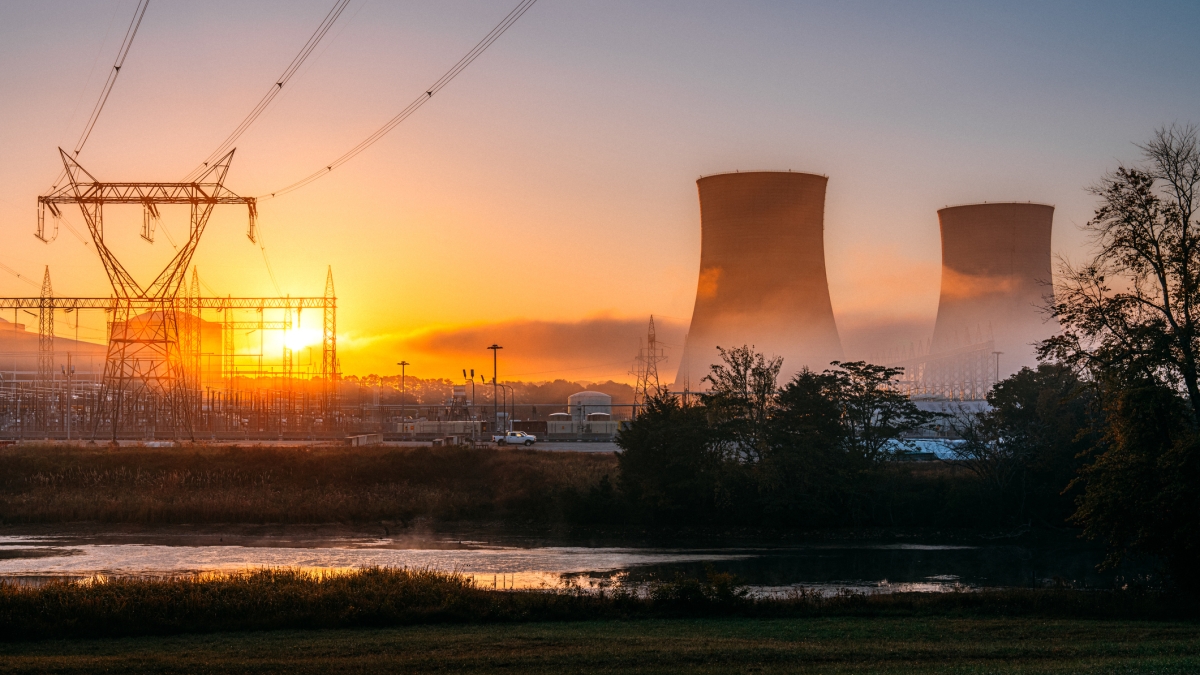 A nuclear power plant with power lines at sunet